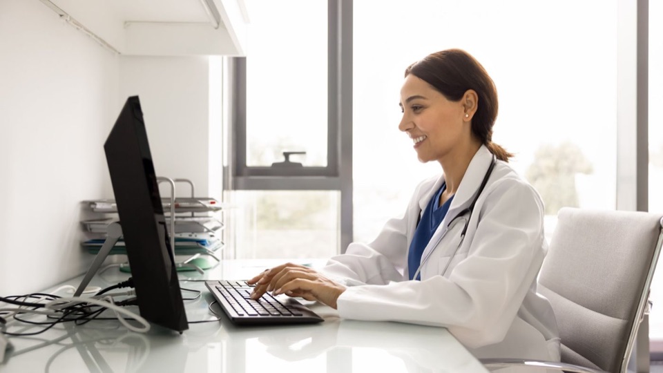 Provider reviewing patient information at a computer
